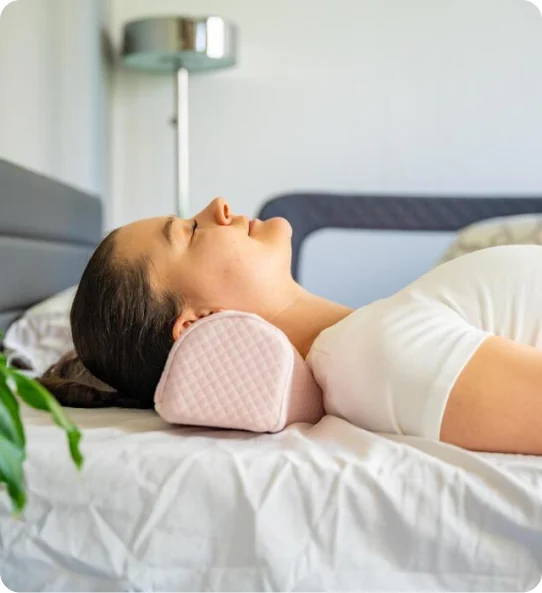 Woman sleeping on a cervical support pillow