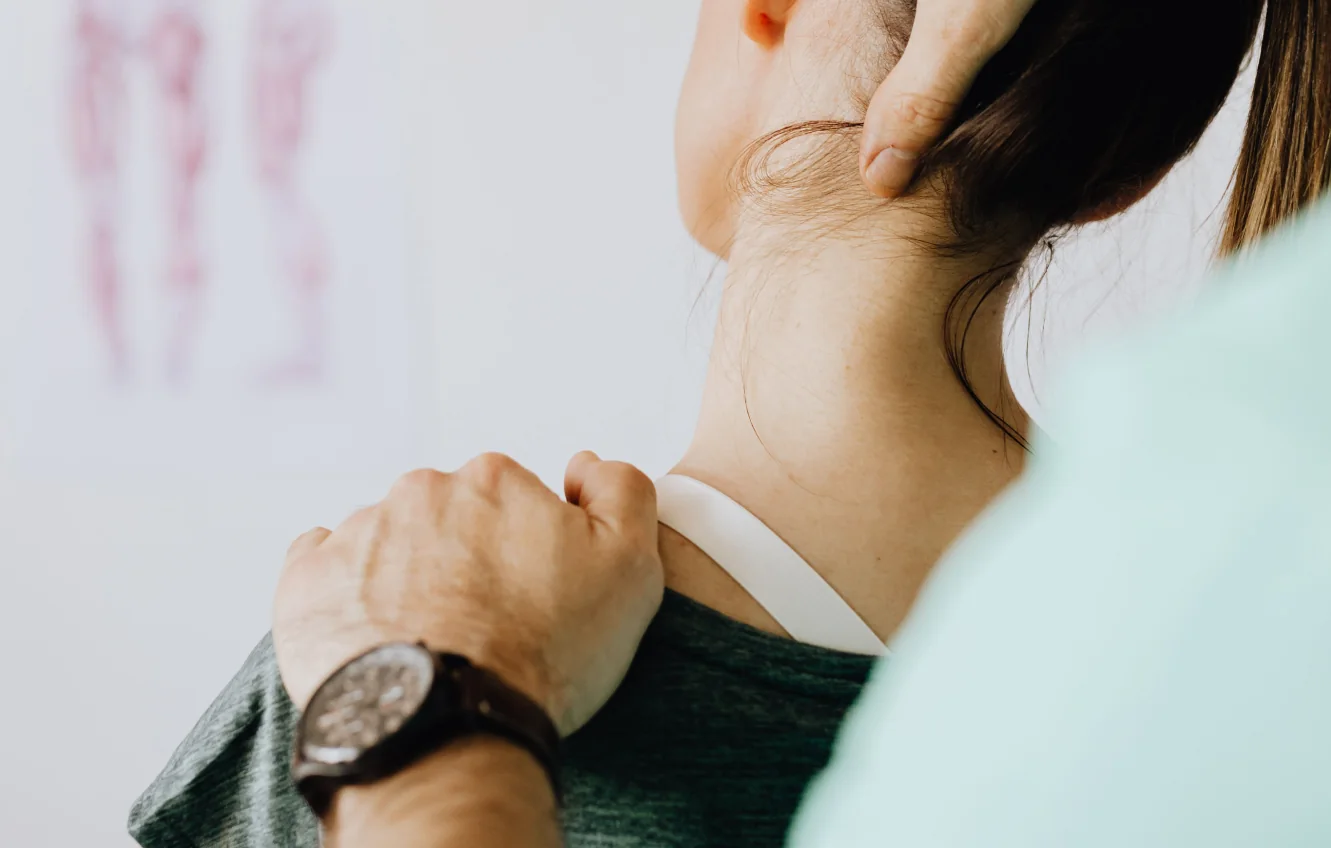 Chiropractor treating a patient's neck and shoulder