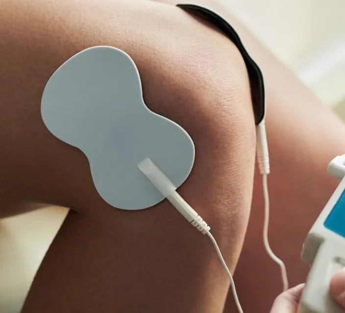 Electrical muscle stimulation pad on a shoulder